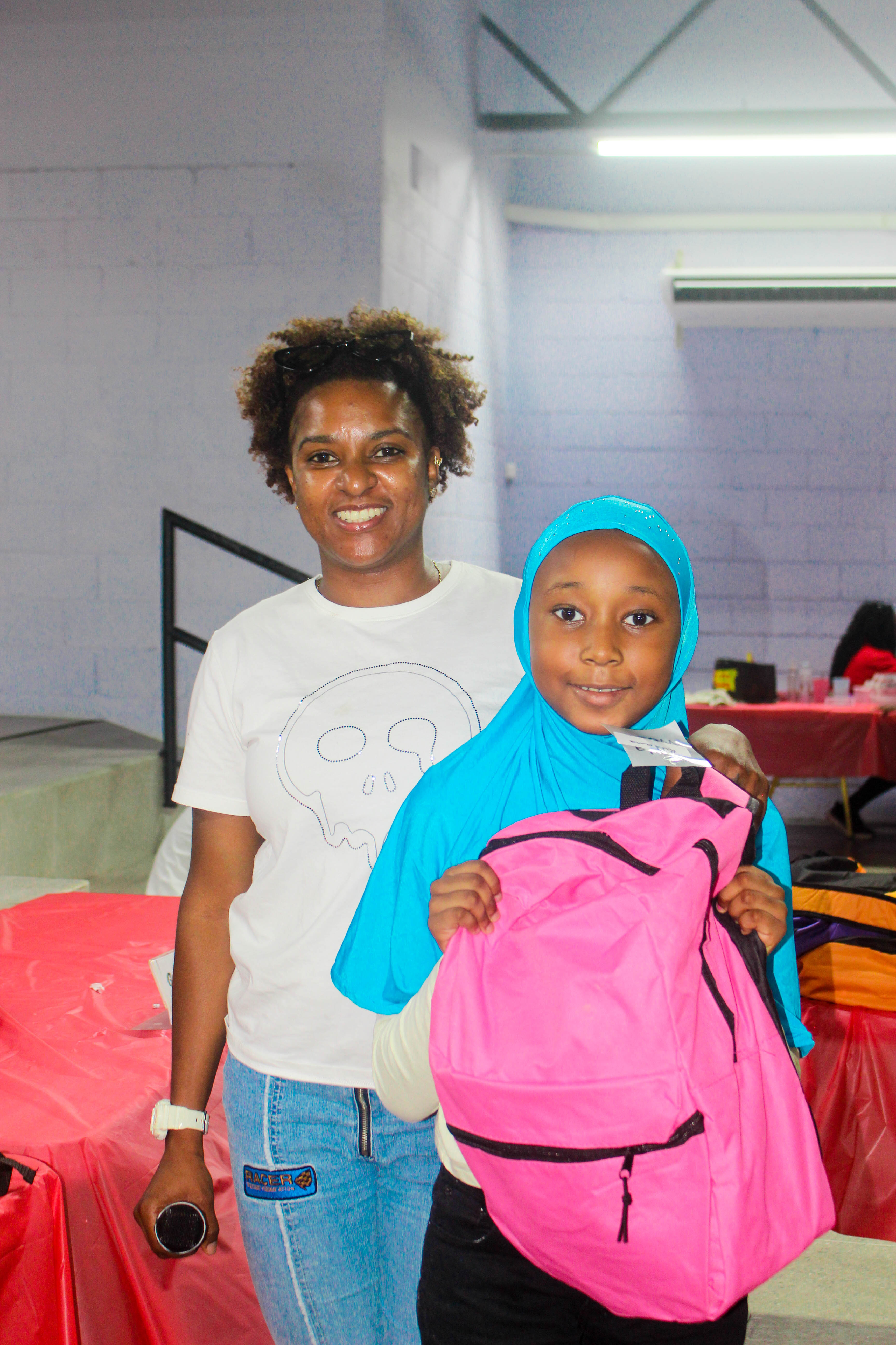 A student receiving a backpack during the Trinidad community support event